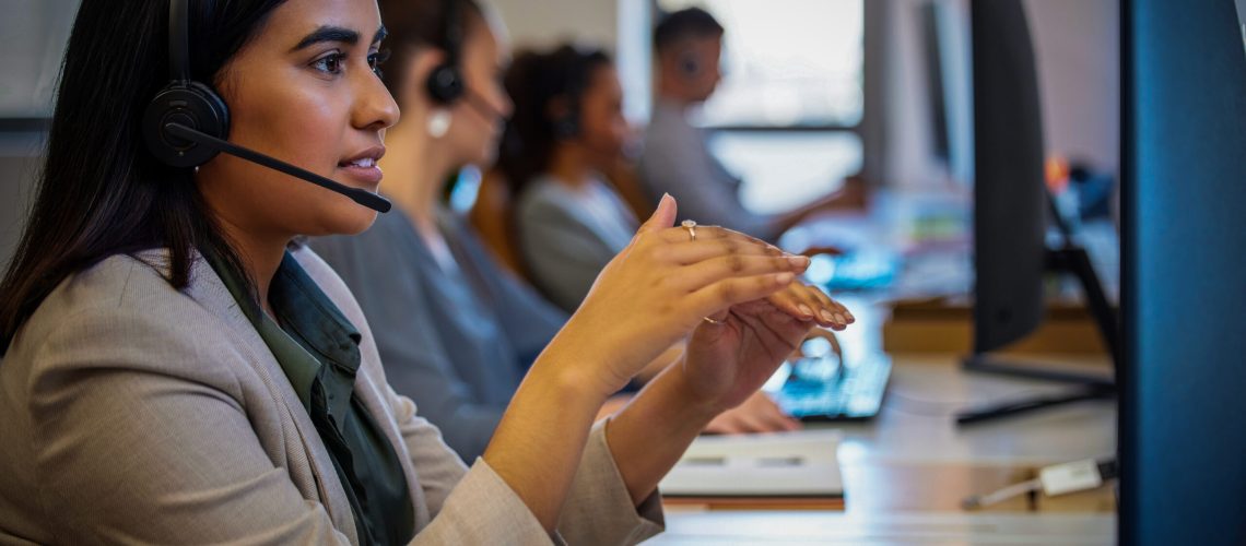 Call center, discussion and woman with headphone, computer and communication in modern office. Conversation, support and telemarketing agent in workplace for deal, consulting and customer service